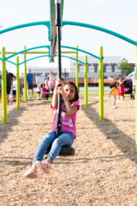 Child playing on new playground at Happyland Play Park Sneak Peek event