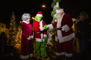 mrs. clause, the grinch and santa at light the ranch event